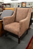 A modern tweed style upholstered tub shaped armchair.