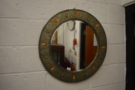 A decorative circular wall mirror.