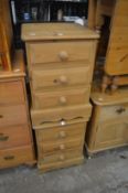 A pair of pine three drawer bedside chests.