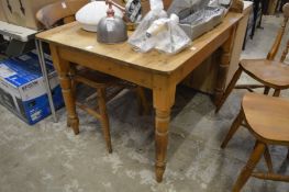 A small pine kitchen table.