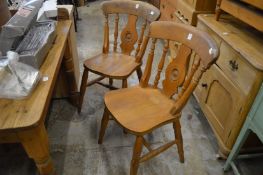A set of four beech kitchen chairs.