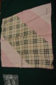 A Burberry silk scarf, pink and check design.