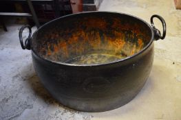 An old cast iron cooking pot.