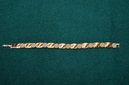 A Trifari birthday ribbon bracelet.