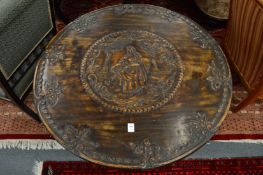 An unusual George III mahogany circular tilt-top tripod table with carved decoration.