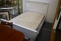 An Ikea Hemnes white painted double bed frame with mattress.
