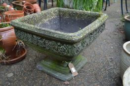 A reconstituted stone square shaped pedestal planter.