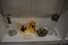 A cut glass claret jug with plated mounts and other decorative items.