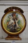 A large Continental pottery vase moulded with a scene of dead game.