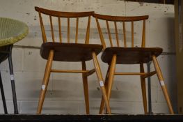 A pair of Ercol stick back chairs.