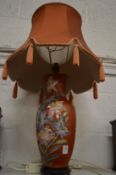 A Chinese vase lamp with shade.
