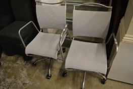 A pair of stylish office swivel armchairs.