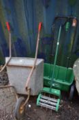 A wheelbarrow, lawn spiker and lawn seeder.