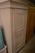 A grey painted pine single door cupboard.