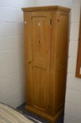 A pine floor standing single door cupboard.