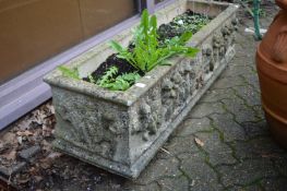 A large reconstituted stone rectangular plant trough.