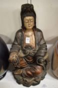 A painted carved wood model of a seated female Chinese Deity.