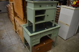 A small green painted cabinet and a similar kneehole dressing table.
