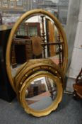 Four decorative gilt framed mirrors.