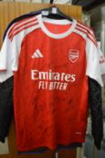 An Arsenal shirt, bears signatures.