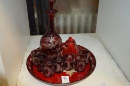 Ruby glass liqueur set and a paperweight.