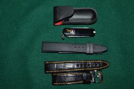 A Victorinox Chopard miniature pen knife with a leather case and two watch straps.