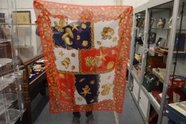 A large silk scarf decorated with seashells.