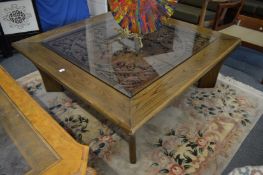 A large square shaped Chinese elm coffee table, the central panel carved with dragons.