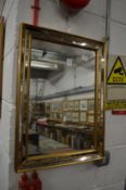 A small decorative gilt framed mirror.
