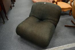 An usual upholstered low chair.