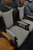 A pair of mahogany framed open armchairs.