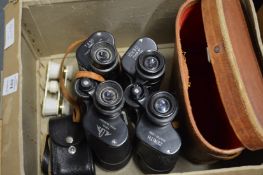 Two pairs of binoculars and a pair of opera glasses.