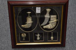 Framed and glazed set of miniature Eastern items to include two jambiya's.