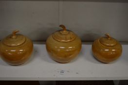 Three turned wood bowls and covers.