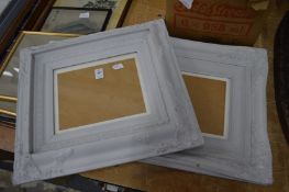 A pair of painted picture frames.