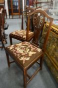 A set of six 19th century mahogany framed dining chairs with needlework upholstered drop-in seats.