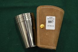 A set of travelling cups in a leather case.