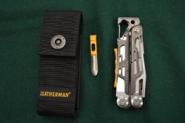 A Leatherman multi-tool with case.