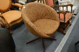 An animal print upholstered swivel tub chair.