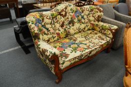 A Continental settee, upholstered in an exotic fabric with birds amongst trees.