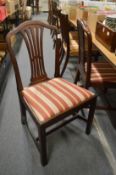 A pair of mahogany dining chairs with drop-in seats.