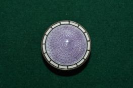 A silver and enamel pill box.