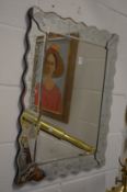 A Venetian style wall mirror.