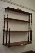 A set of mahogany wall shelves.