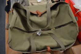 A large canvas and leather trimmed holdall.