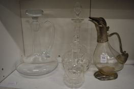 A duck shaped claret jug and three decanters.