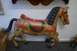 A large painted carved wood model of a prancing horse.
