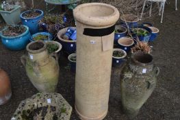 A pair of pottery urns and a chimney pot.