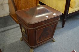 A 19th century mahogany sarcophagus form coal box on brass paw feet.