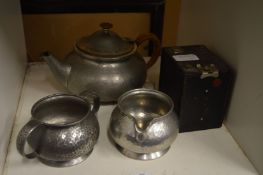 Pewter three piece tea service and an old camera.